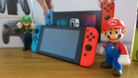 Nintendo Switch with Mario character figurines